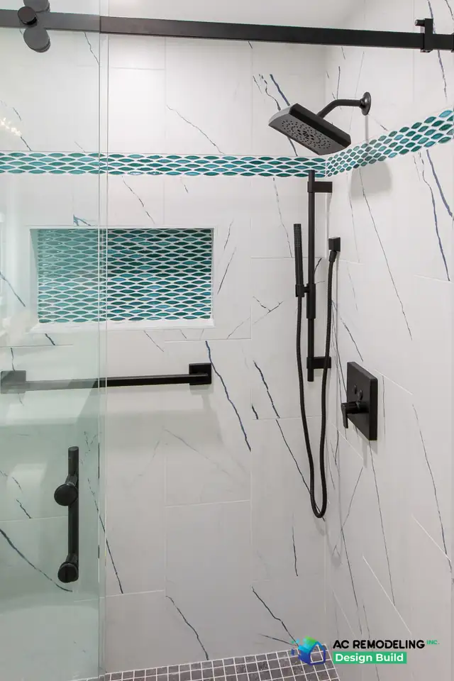 Hall bath shower in Gaithersburg, MD with marble-look tile, teal glass mosaic band, niche and matte black fixtures