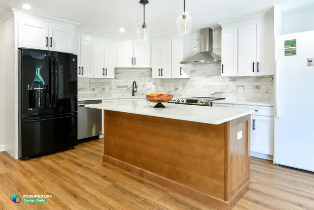 In-law suite basement kitchen in Rockville, MD with white shaker cabinetry, wood island and quartz countertop