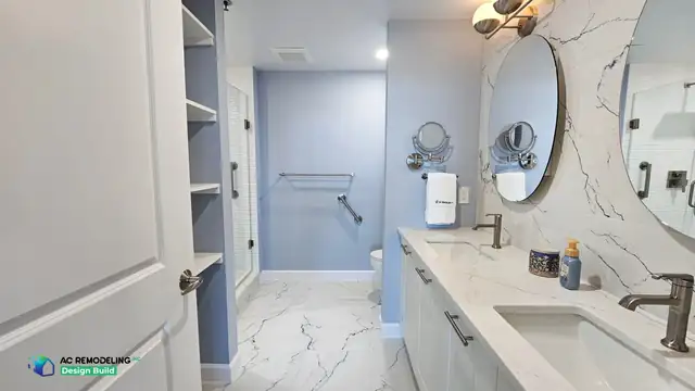 Primary bathroom remodel in Rockville, MD with open linen shelving, frameless glass shower and marble-look porcelain floor