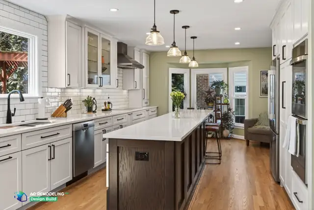 Galley kitchen with white shaker cabinets, a white subway tile backsplash, glass pendants and a wood-base island