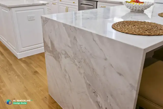 Mitered marble waterfall edge on a kitchen peninsula in a white kitchen remodel in Bethesda, MD