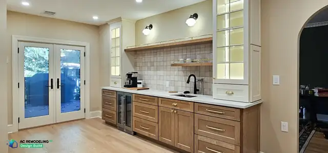 Beverage and coffee bar with stained wood cabinetry, wine fridge and brass rail in a Bethesda, MD kitchen