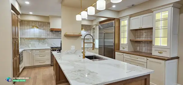 Bethesda, MD kitchen built from a 3D design, with a large quartzite island, fluted glass pendants and stained wood base